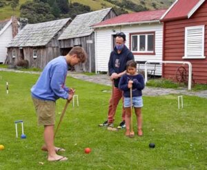 Family playing croquet at the museum