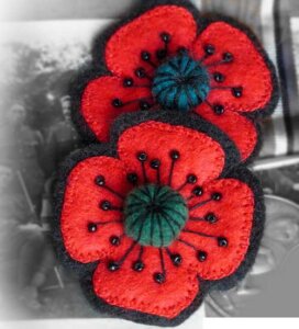 ANZAC Poppy Brooch featuring 4 red petals, green centre and black bead and thread detail